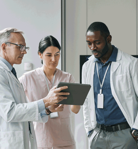 Group of doctors looking at clipboard.