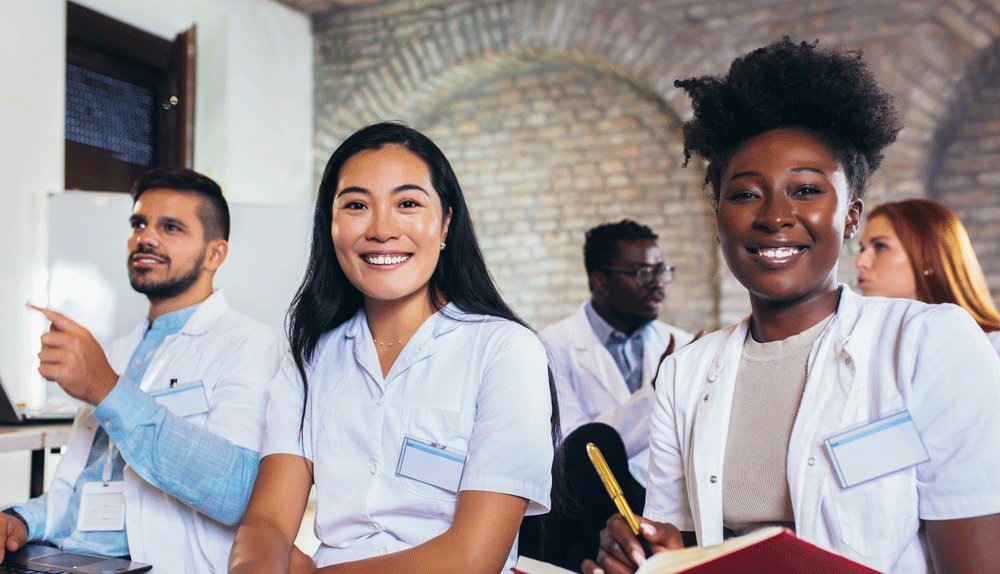 medical students or doctors smiling and listening.